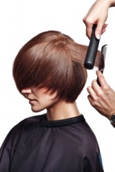 A woman having her hair styled. A woman having her hair styled.