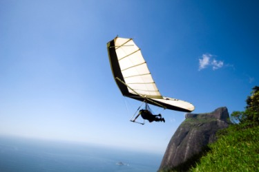 A hang glider in flight. A hang glider in flight.