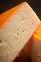 A wedge of havarti cheese. A wedge of havarti cheese.