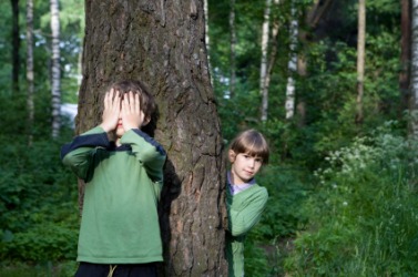 Two children playing hide-and-seek. Two children playing hide-and-seek.