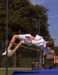 A man participating in a high jump compitition. A man participating in a high jump compitition.