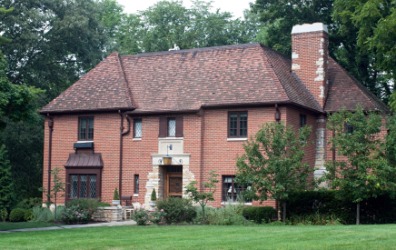 A brick home with a hip roof. A brick home with a hip roof.
