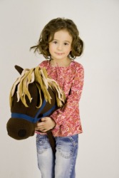 A child riding a hobbyhorse. A child riding a hobbyhorse.