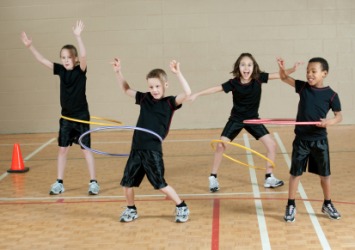 Children playing with hula hoops. Children playing with hula hoops.