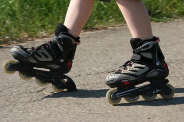 A child wearing a pair of in-line skates. A child wearing a pair of in-line skates.