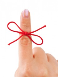 A red bow around the index finger. A red bow around the index finger.