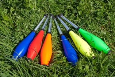 A row of brightly colored Indian clubs. A row of brightly colored Indian clubs.