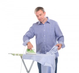 A man ironing a shirt. A man ironing a shirt.