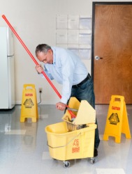 A janitor cleaning the floor. A janitor cleaning the floor.