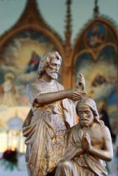 A statue of Jesus being baptised by John the Baptist. A statue of Jesus being baptised by John the Baptist.