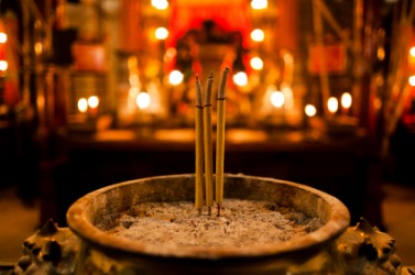 Burning joss sticks. Burning joss sticks.