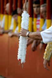A man holding two banderillas. A man holding two banderillas.