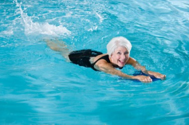 A woman using a kickboard. A woman using a kickboard.