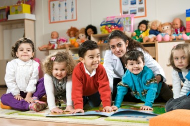 A kindergarten class with their teacher. A kindergarten class with their teacher.