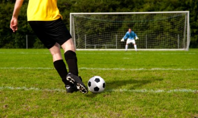 A soccer player wearing knee-high socks. A soccer player wearing knee-high socks.
