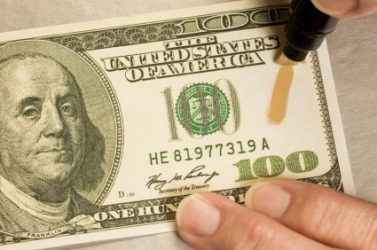 Testing for counterfeit money. Testing for counterfeit money.