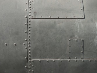 A piece of metal with rivets. A piece of metal with rivets.