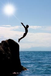 A boy about to plunge into the ocean for a swim. A boy about to plunge into the ocean for a swim.