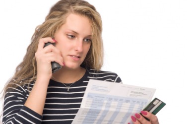 This woman is not happy with her telephone charges. This woman is not happy with her telephone charges.