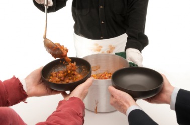 Soup being doled out at a soup kitchen. Soup being doled out at a soup kitchen.
