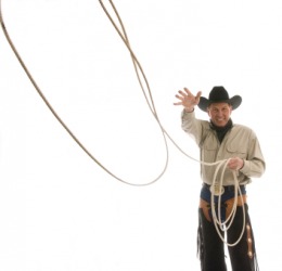 A cowboy using a lariat. A cowboy using a lariat.