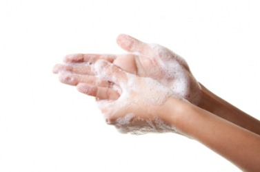 A person has created a soapy lather on their hands. A person has created a soapy lather on their hands.