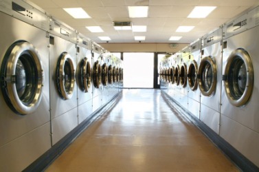 Rows of washing machines at a laundromat. Rows of washing machines at a laundromat.