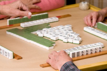 People playing mah-jongg. People playing mah-jongg.