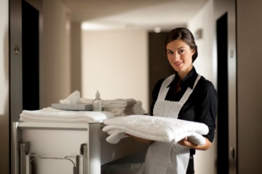 A hotel maid at work. A hotel maid at work.