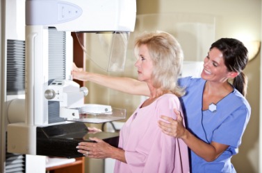 A woman about to receive a mammogram. A woman about to receive a mammogram.