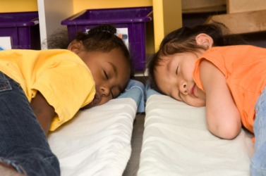 Two children taking a nap at preschool. Two children taking a nap at preschool.