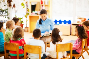A teacher narrates a story to her class. A teacher narrates a story to her class.