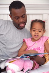 Daddy provides the narration for his child's bedtime story. Daddy provides the narration for his child's bedtime story.