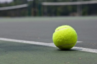 Tennis ball sitting at the base line. Tennis ball sitting at the base line.