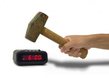 Someone about to bash a clock with a hammer. Someone about to bash a clock with a hammer.