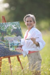 A woman painting in a field. A woman painting in a field.