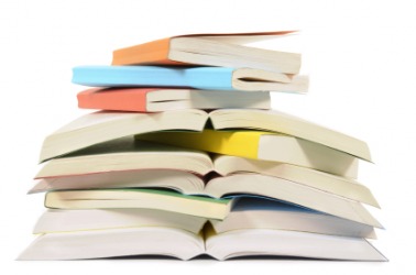 A stack of paperback books. A stack of paperback books.