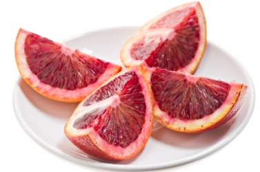 This blood orange has been quartered. This blood orange has been quartered.