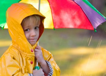 A child in a yellow raincoat. A child in a yellow raincoat.