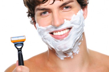 A man using a razor to shave. A man using a razor to shave.