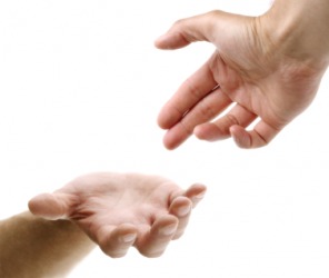 One hand reaches for another. One hand reaches for another.