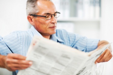 A man reading a newspaper. A man reading a newspaper.