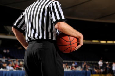 A basketball referee. A basketball referee.