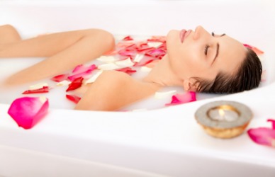 A woman taking a refreshing bath. A woman taking a refreshing bath.