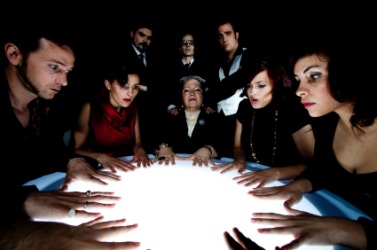 A group of people holding a seance. A group of people holding a seance.