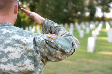 A soldier gives a salute to fallen comrades. A soldier gives a salute to fallen comrades.
