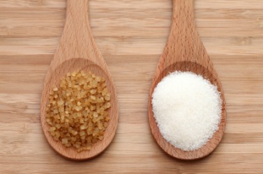 Spoons full of brown and white sugar. Spoons full of brown and white sugar.