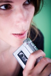 A woman using a tape recorder. A woman using a tape recorder.