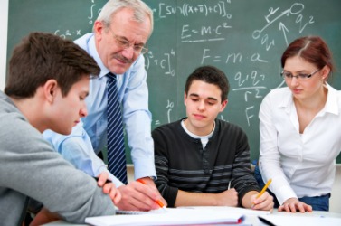 A math teacher with his students. A math teacher with his students.