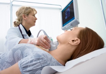 A woman has an ultrasound of her thyroid. A woman has an ultrasound of her thyroid.